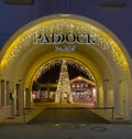 Entrance arch of modern french Paddock shopping outlet center with christmas tree, decoration and night lighting