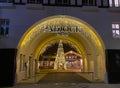 Entrance arch of modern french Paddock shopping outlet center with christmas tree, decoration and night lighting