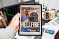 Man reading on iPad Pro about Notre-Dame de Paris fire