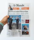 Man hand holding Le Monde French newspaper