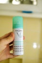 POV personal perspective male hand holding bottle with Vichy deodorant