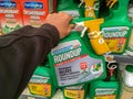 Customer buying roundup in a french Hypermarket. Roundup is a brand-name of an herbicide containing glyphosate, made by Monsanto C
