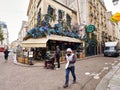 person on sidewalk paris street and bar cafe terrace