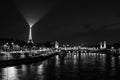 Paris, France - April 1, 2019: Panoramic view of the Eiffel Tower in Paris over the Seine River with boats at night Royalty Free Stock Photo