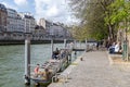 Paris, France, April 1, 2017: Quay at the edge of the canal with walkers. Geode in the background. Villette Park