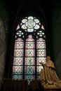 Paris, France - April 1, 2019: Stained glass window inside the Notre Dame Cathedral, Paris, France Royalty Free Stock Photo