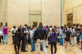 PARIS, FRANCE - APRIL 8, 2011: Students walking inside the Louvre Museum near Mona Lisa portrait