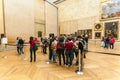 PARIS, FRANCE - APRIL 8, 2011: Students walking inside the Louvre Museum near Mona Lisa portrait