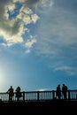 Tourists enjoy the warmth of spring, on a bridge of the Seine river in Paris.