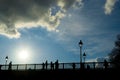 Tourists enjoy the warmth of spring, on a bridge of the Seine river in Paris.