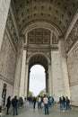 Paris, France - April 2, 2019: tourists under the Arc de Triomphe Triumphal Arch in Champs Elysees. Royalty Free Stock Photo