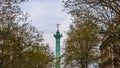 Paris / France - April 6, 2019: View of the July Column Colonne de Juillet among spring trees in Paris