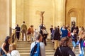 PARIS, FRANCE - APRIL 8, 2011: Visitors walking inside the Louvre Museum near Winged Victory of Samothrace