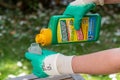 Paris, France - August 15, 2018 : Gardener using Roundup herbicide in a french garden. Roundup is a brand-name of an herbicide con