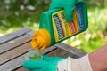 Paris, France - August 15, 2018 : Gardener using Roundup herbicide in a french garden. Roundup is a brand-name of an herbicide con Royalty Free Stock Photo