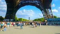 PARIS, FRANCE - AUGUST 8, 2010: Many tourists under Eiffel tower on sunny summer day. Paris, France.