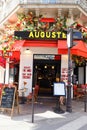 The traditional French cafe Auguste decorated with flowers . It located at famous Rivoli street in Paris, France. Royalty Free Stock Photo