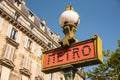 Paris, France. August 2022. Traditional Paris metro sign with buildings in the background Royalty Free Stock Photo