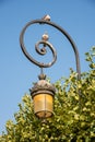 Paris, France. August 2022. Typical and vintage metal street lamp in Paris.