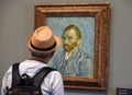 Paris, France - August 29, 2019: Visitor near the Self-Portrait by Vincent van Gogh painting in Museum d`Orsay in Paris, France