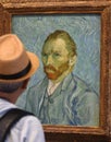 Paris, France - August 29, 2019: Visitor near the Self-Portrait by Vincent van Gogh painting in Museum d`Orsay in Paris, France