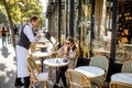 Woman and waiter at the cafe