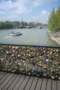 Paris, France: Bridge of arts with love locks, a boat on the seine, eiffel tower