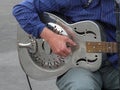 PARIS, FRANCE - CIRCA AUGUST 2011: blues-rock guitarist Rene Miller playing his Dobro guitar on Saint Louis bridge pont Saint-