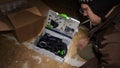 Ime-lapse fast motion of young male unboxing unpacking parcel box Festool