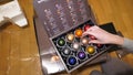 Woman unpacking package with multiple coffee capsules