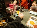 Woman paying Contactless at the shop counter with her HSBC Premier gold card