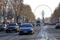 Avenue Champs-Elysees with ferris wheel at horizon in Paris, France