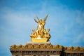 Bright shiny golden statues on the facade of the opera house