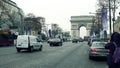 PARIS, FRANCE - DECEMBER, 1, 2017. Champs-Elysees street and famous triumphal arch, Arc de Triomphe. Woman making photo