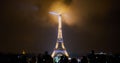 Paris, France - December 23, 2017: People are looking at the Eiffel tower illuminated at night. Royalty Free Stock Photo