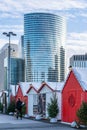 Paris, France - December 8: Tour EDF headquater skyscraper in la defense with Christmas market cabin in foreground