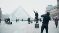 PARIS, FRANCE - DECEMBER, 31, 2016. Tourists posing and making photos near the Louvre, famous French museum. Popular