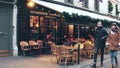 PARIS, FRANCE - DECEMBER, 31, 2016. Walk along beautiful Parisian brasserie, small restaurant, with awnings Royalty Free Stock Photo