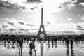 Paris, France, 09.10.2019: Eiffel Tower with tourists taking pictures. Black and white photo