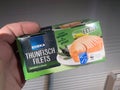 branded Edeka, thunfish filets tin cans package in male hand