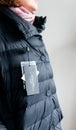 Woman looking at Max mara down jacket buy new clothes price tag