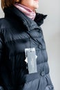 Woman looking at Max mara down jacket buy new clothes price tag