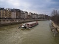 Paris, France February 22, 2013: Cruise ship on the River Seine near the Notre Dame Cathedral in Paris Royalty Free Stock Photo