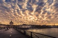 Paris wooden bench on Pont des Arts wooden bridge at sunset