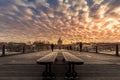 Paris wooden bench on Pont des Arts wooden bridge at sunset