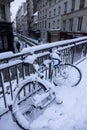 PARIS, FRANCE - FEBRUARY 7, 2018: Snow in Paris, early morning in the street, bicycles are covered with snow