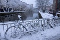 PARIS, FRANCE - FEBRUARY 7, 2018: Snow in Paris, early morning in the street, bicycles are covered with snow