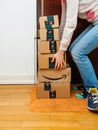 Woman and multiple Amazon Prime cardboard box