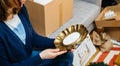 Side view of woman unboxing new Zara Home product - beautiful vintage forged