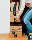 Woman lifting heavy Amazon cardboard boxes